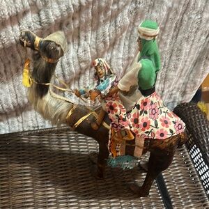 Hand crafted leather camel and two riders 19” x 16”